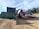 A fleet of trucks parked in a logistics yard under a clear sky.