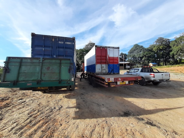 Fleet of cargo trucks lined up under a clear sky.