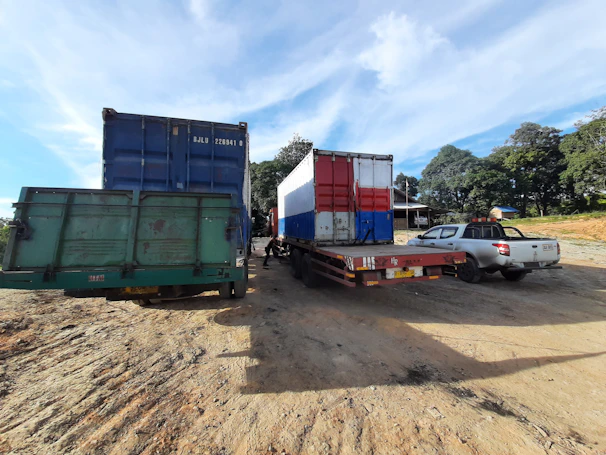 Image of cargo trucks lined up, ready for transport under a clear sky