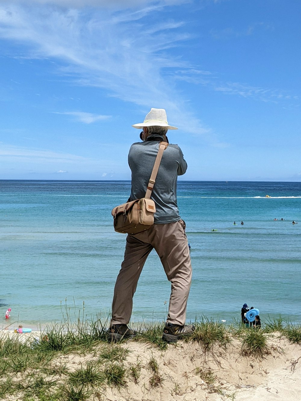 a man standing on a beach looking out at the ocean