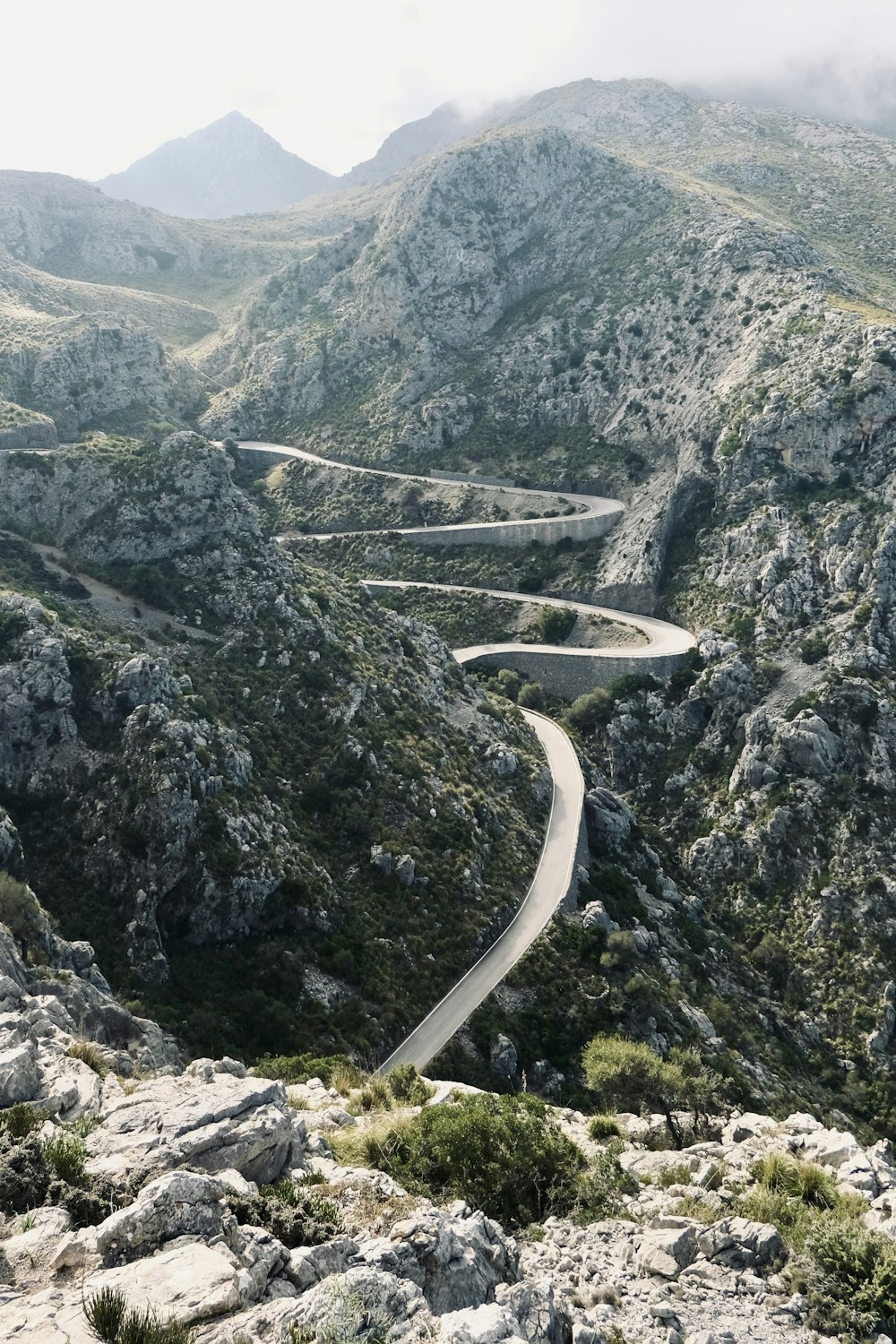 a winding road in the middle of a mountain range