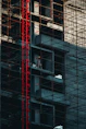 a man standing on a scaffolding in front of a tall building