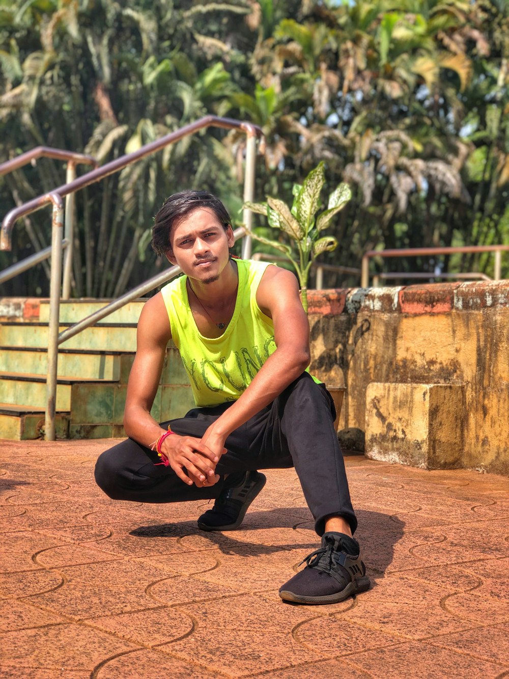 a man in a yellow shirt and black pants