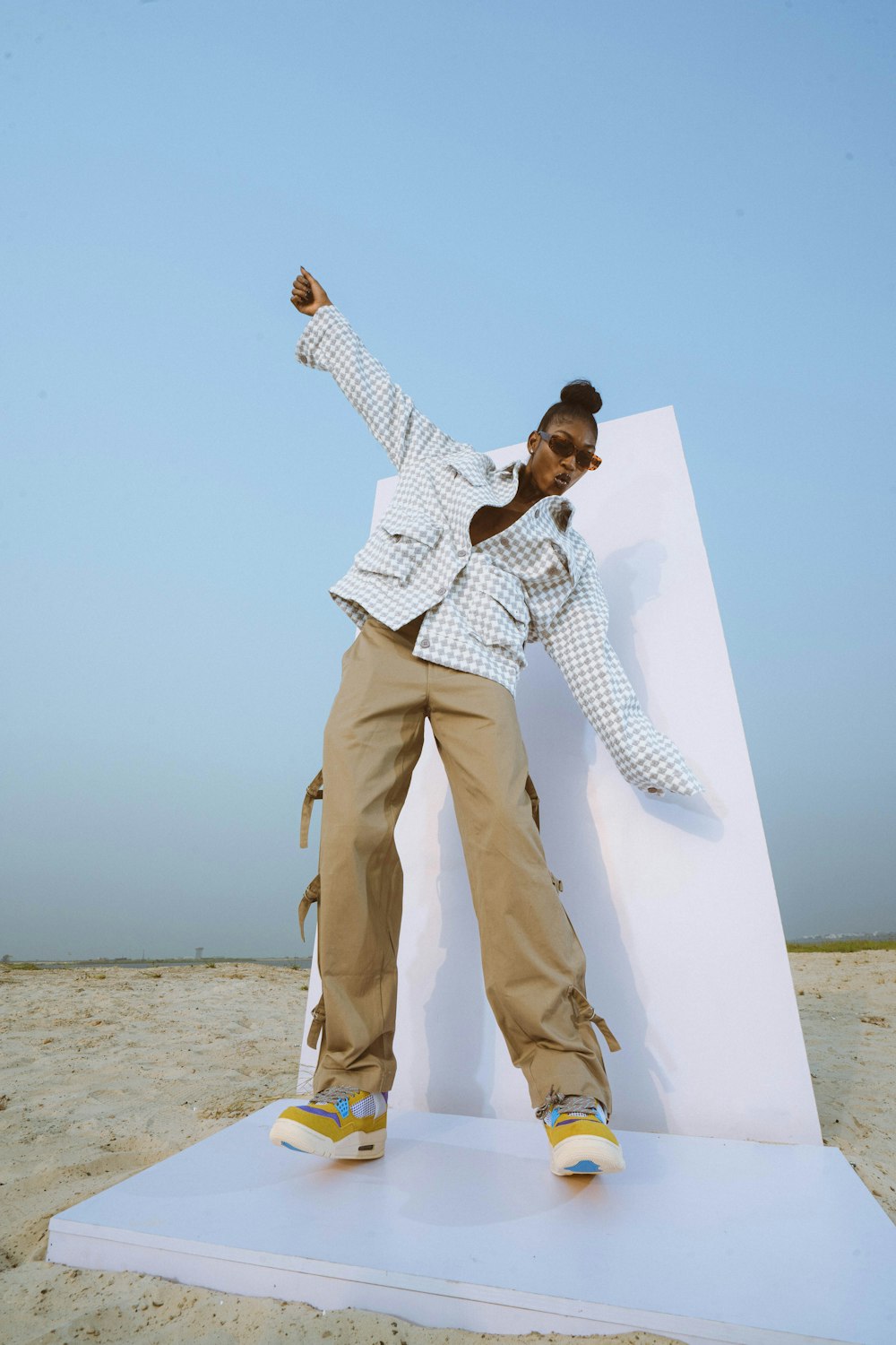a woman standing on top of a white object