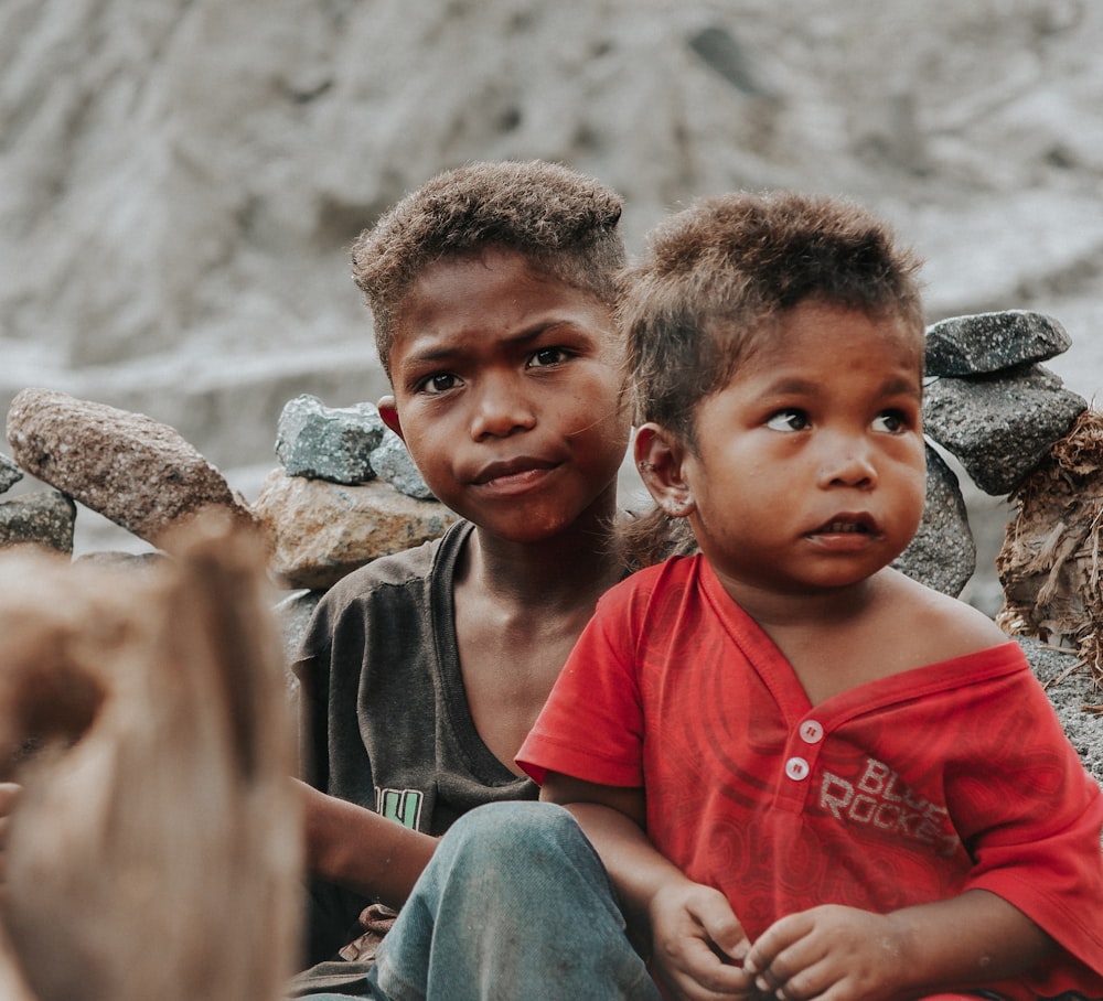 two young boys sitting next to each other