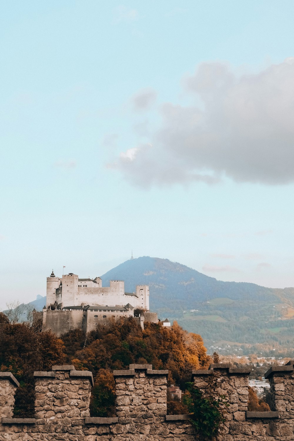 a castle sitting on top of a stone wall