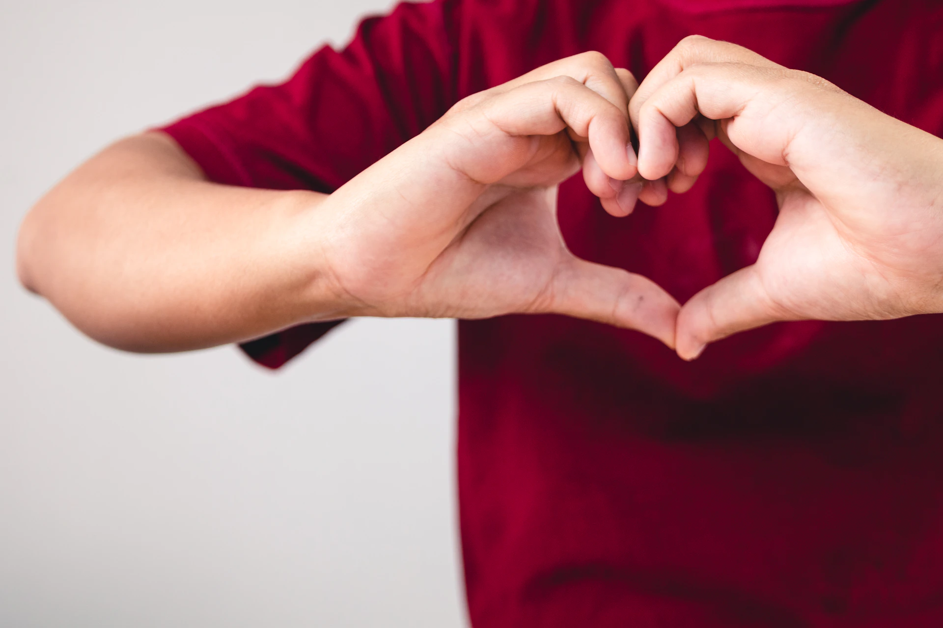 a person making a heart with their hands