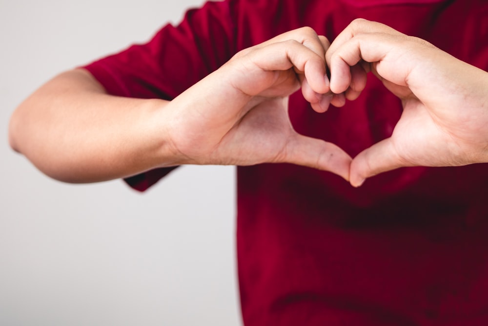 a person making a heart with their hands