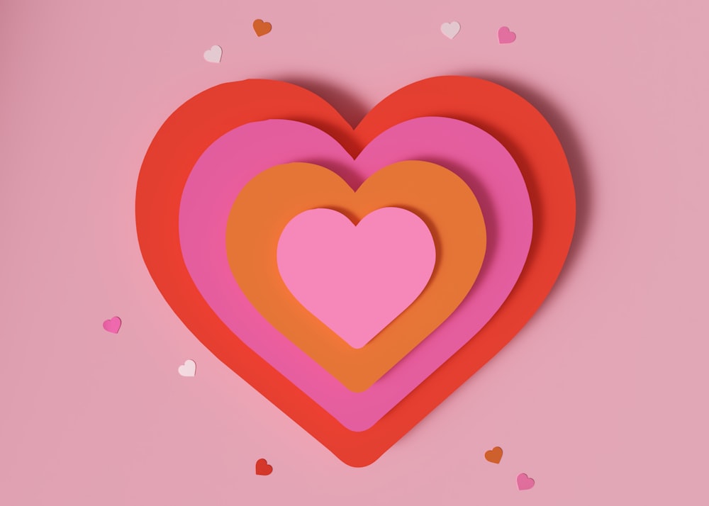 a paper heart on a pink background with confetti