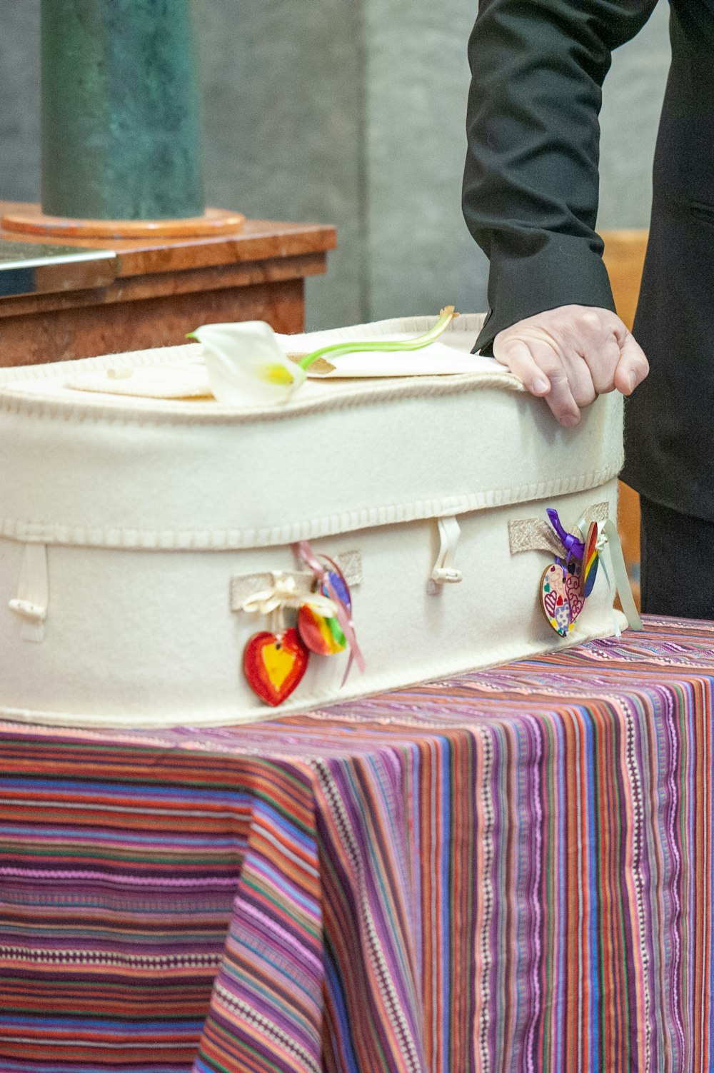 a person holding onto a suitcase on a table