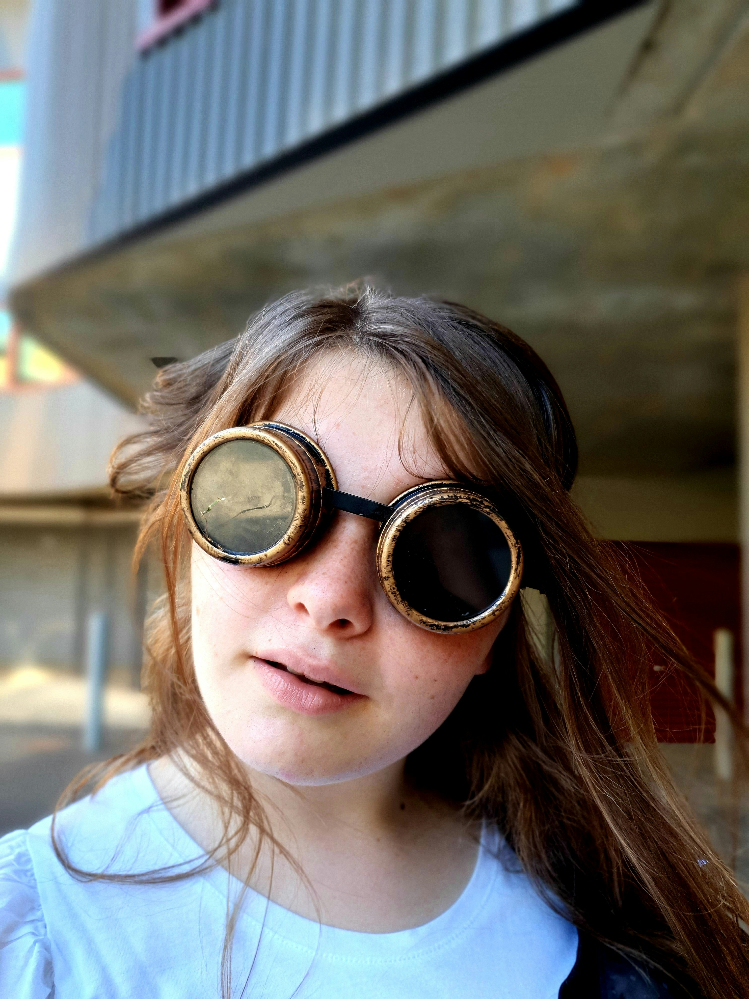 A young girl wearing a pair of goggles photo Free Glasses woman Image