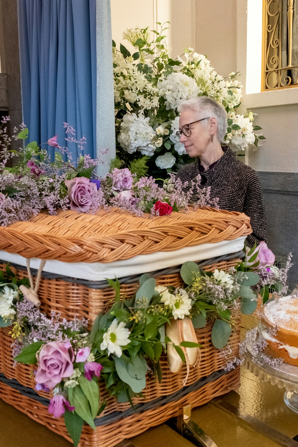 a man sitting in front of a basket filled with flowers