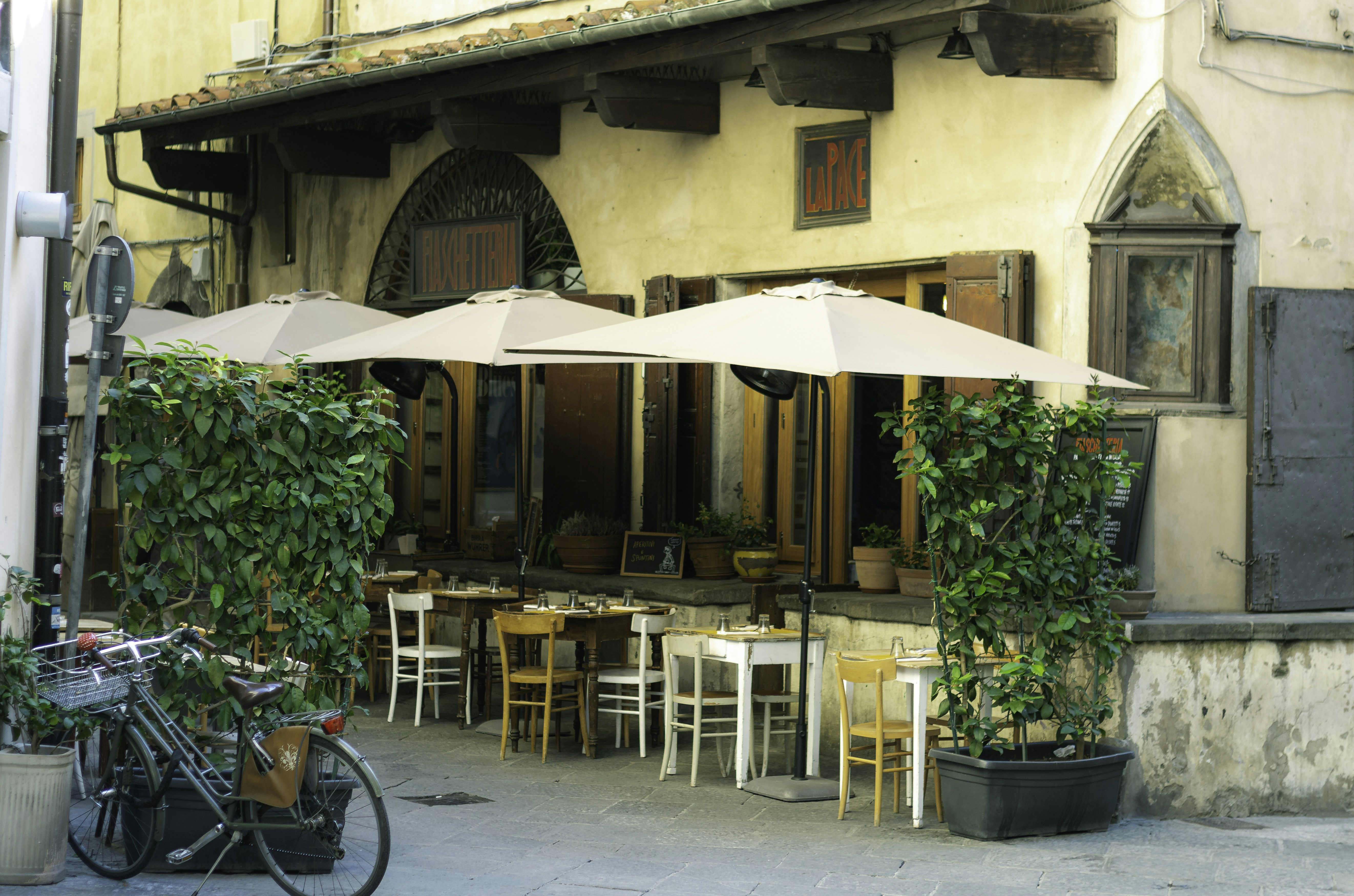 a building with tables and chairs outside of it