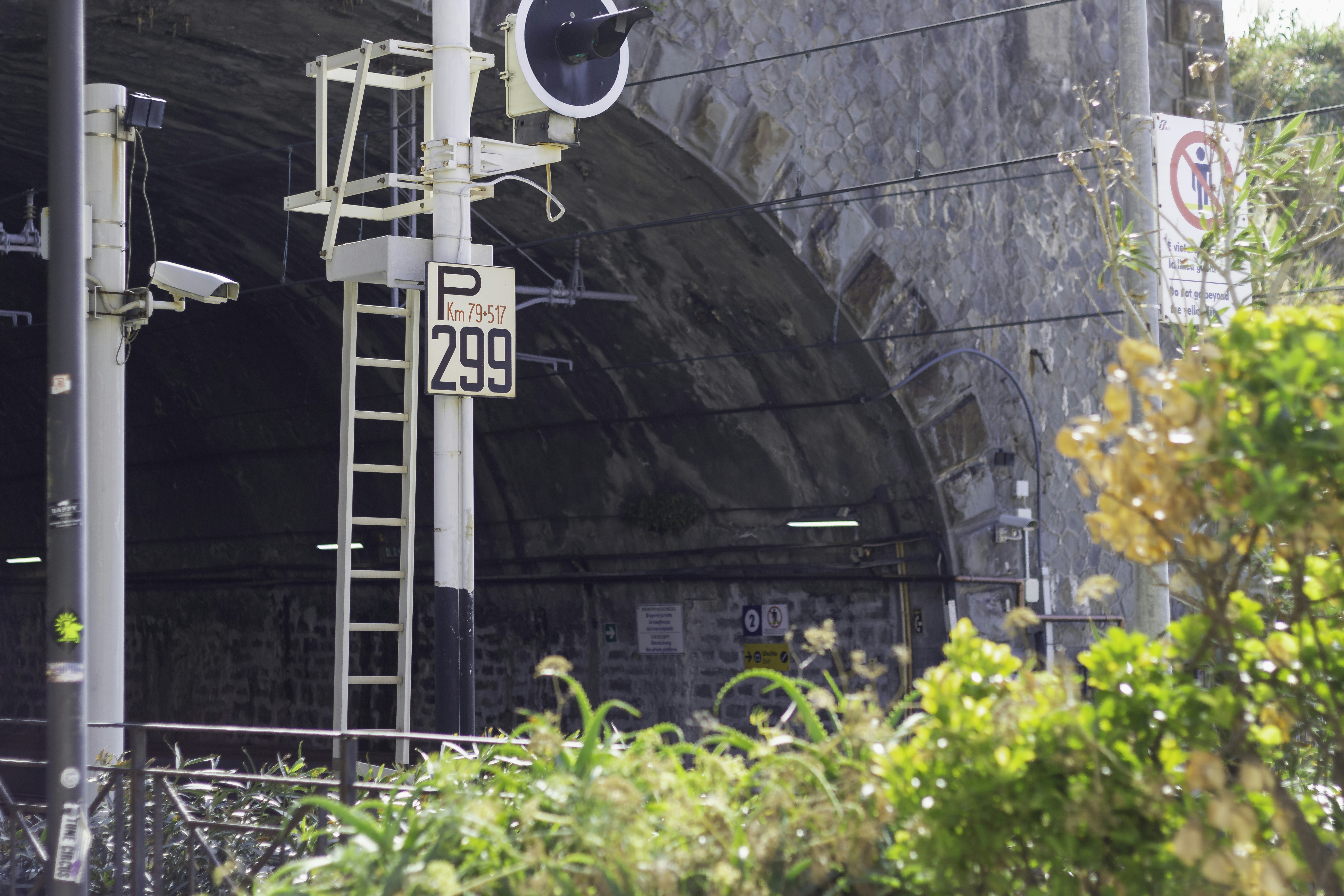 a traffic light on a pole next to a tunnel
