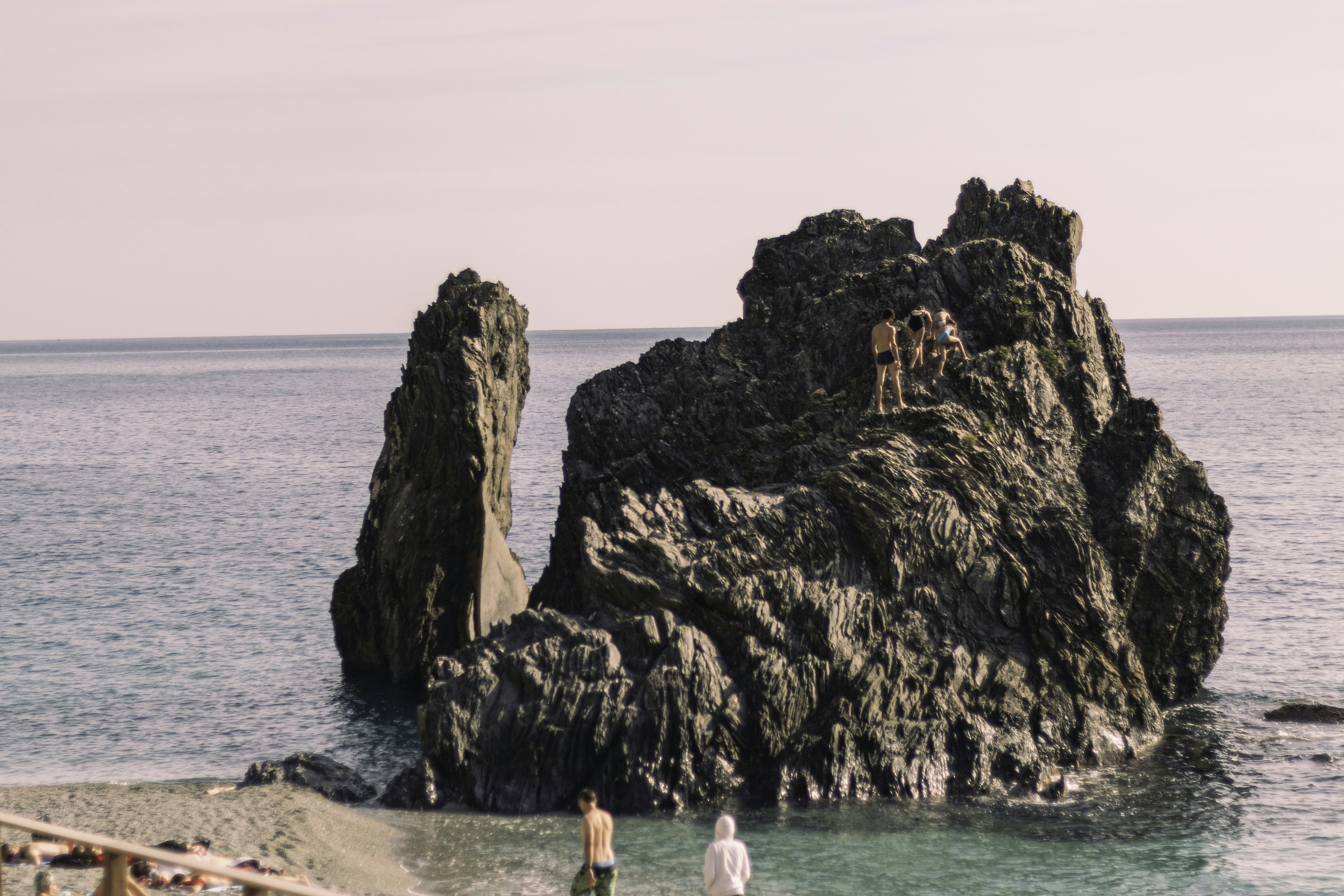 a group of people standing on top of a rock formation