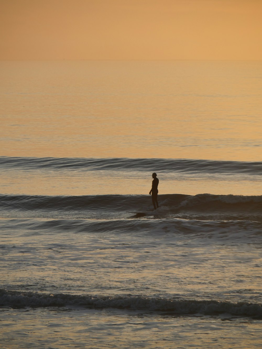 a person standing on a surfboard in the ocean