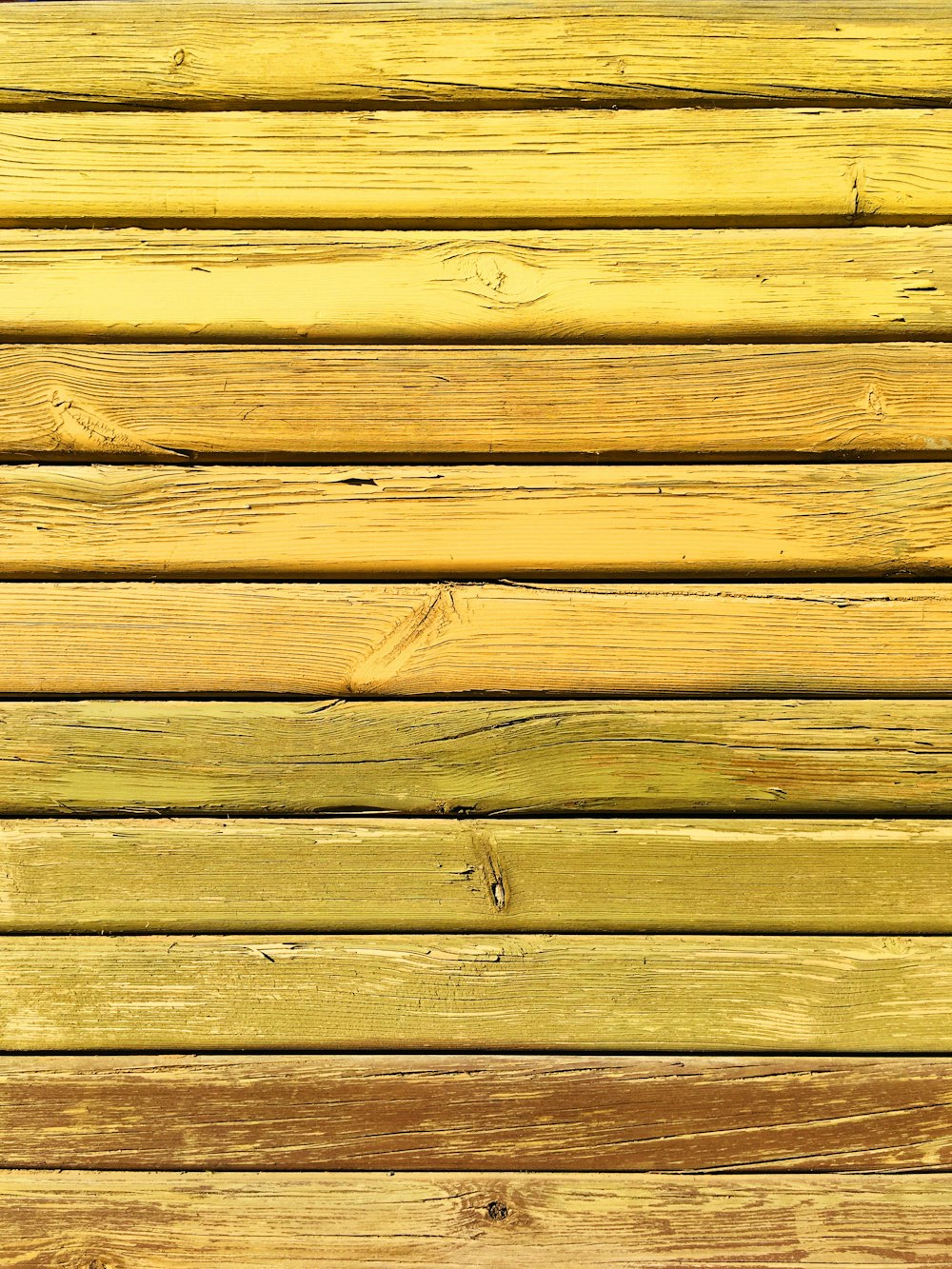 a close up of a yellow wooden wall