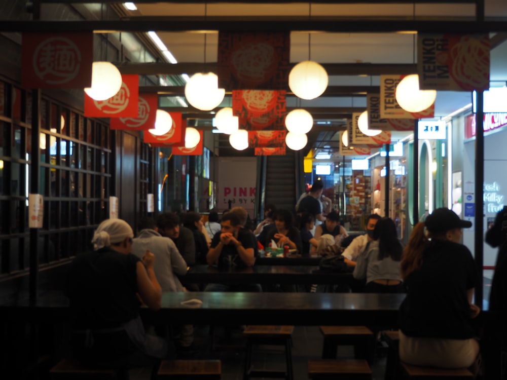 a group of people sitting at a table in a restaurant