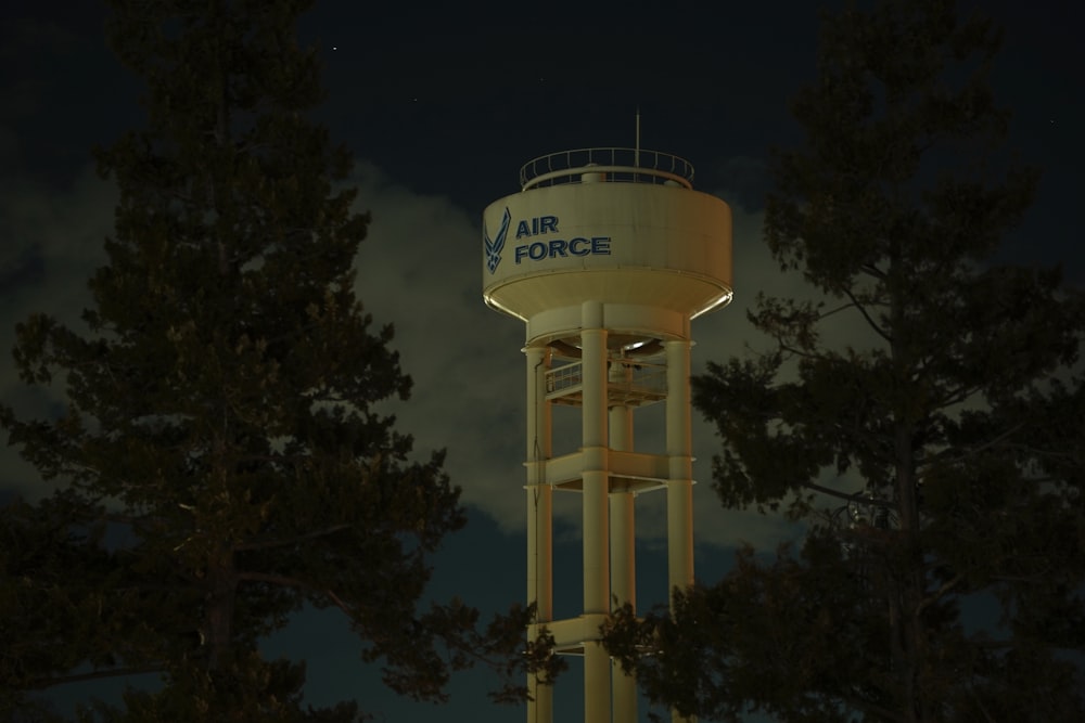 a water tower at night with a sky background