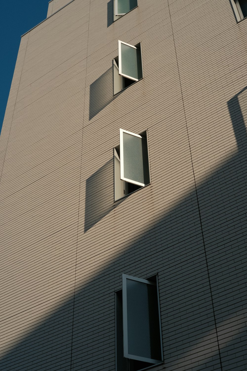 a tall building with several windows on the side of it
