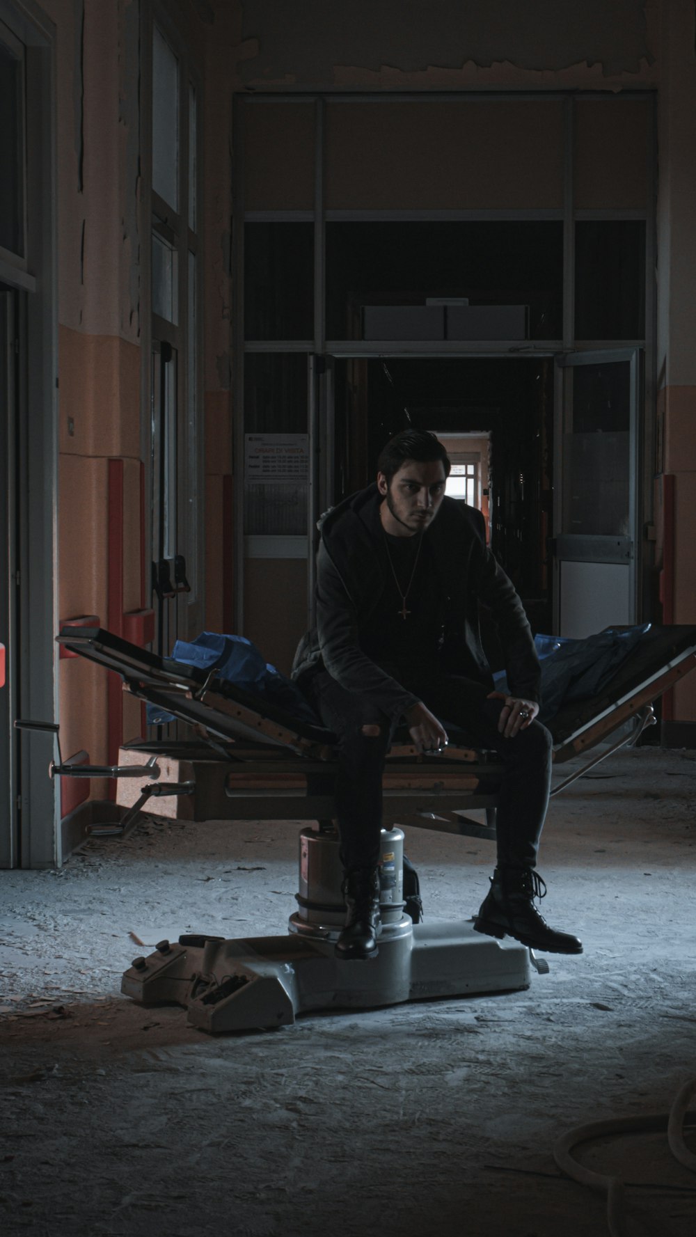 a man sitting on a hammock in a building