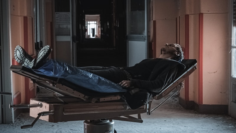 a man laying on top of a hospital bed