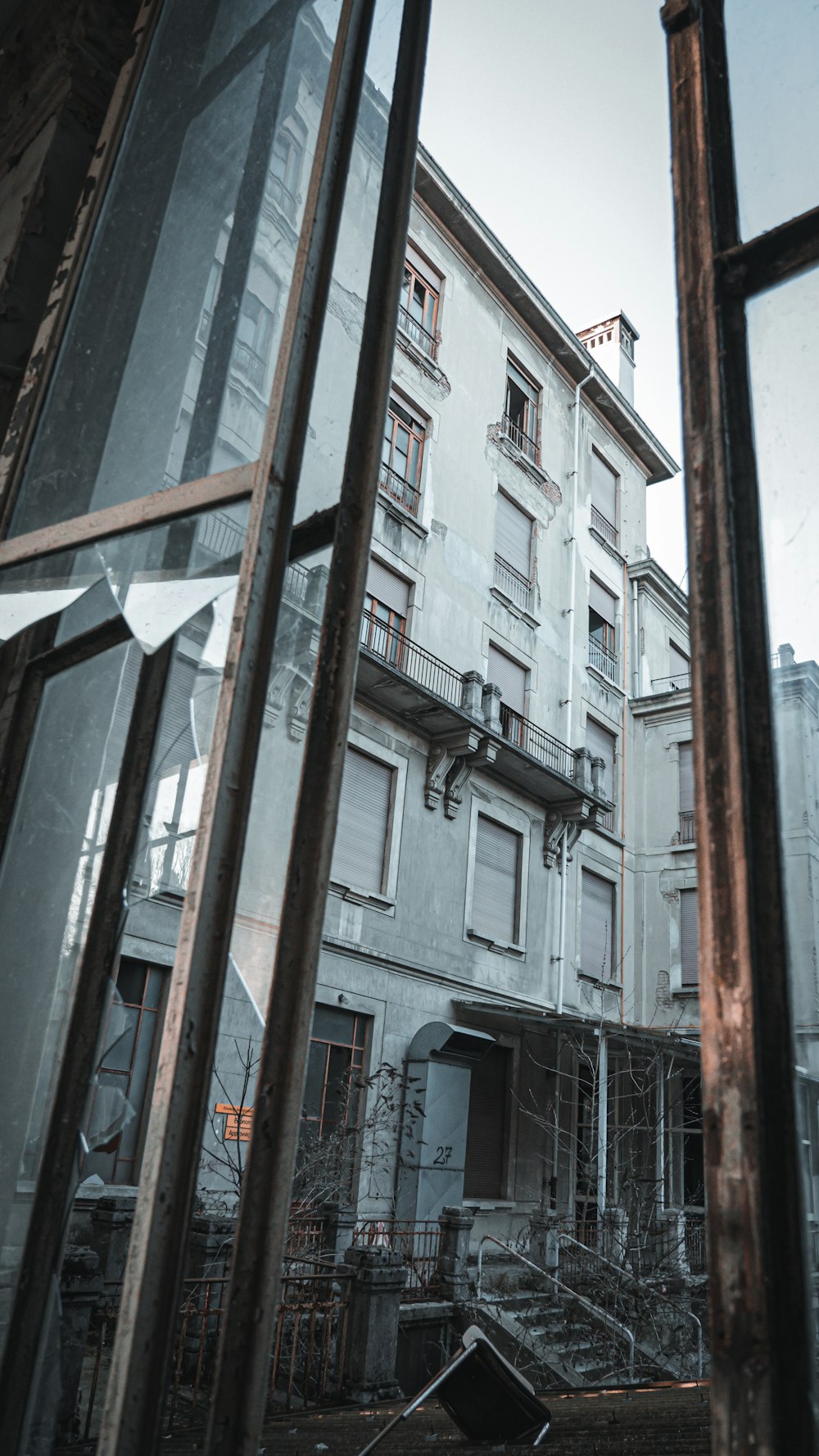 an old building is seen through a broken window