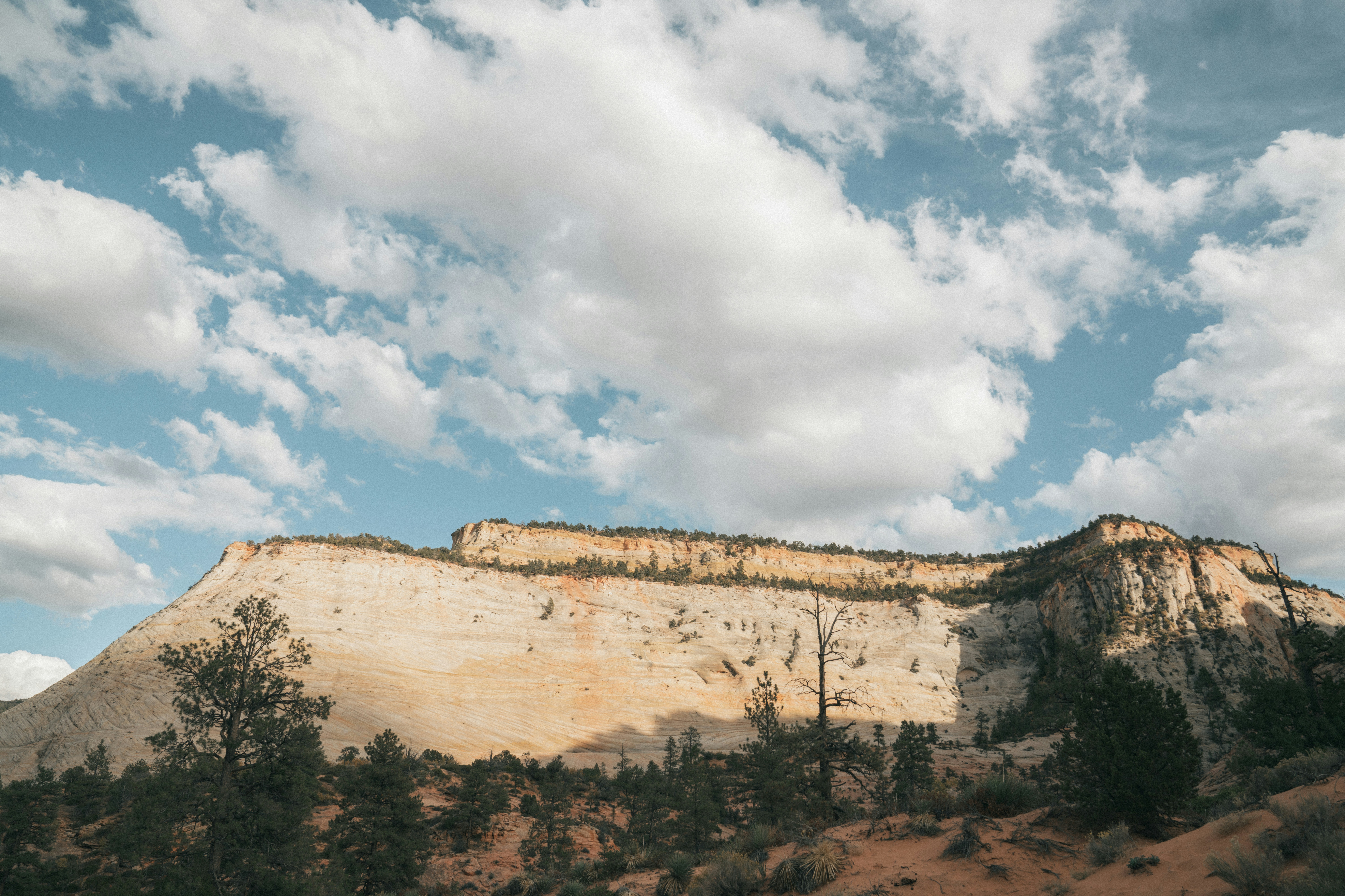 a view of a mountain with clouds in the sky
