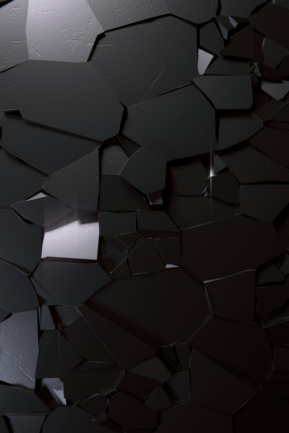 a bunch of black pieces of glass on a wall