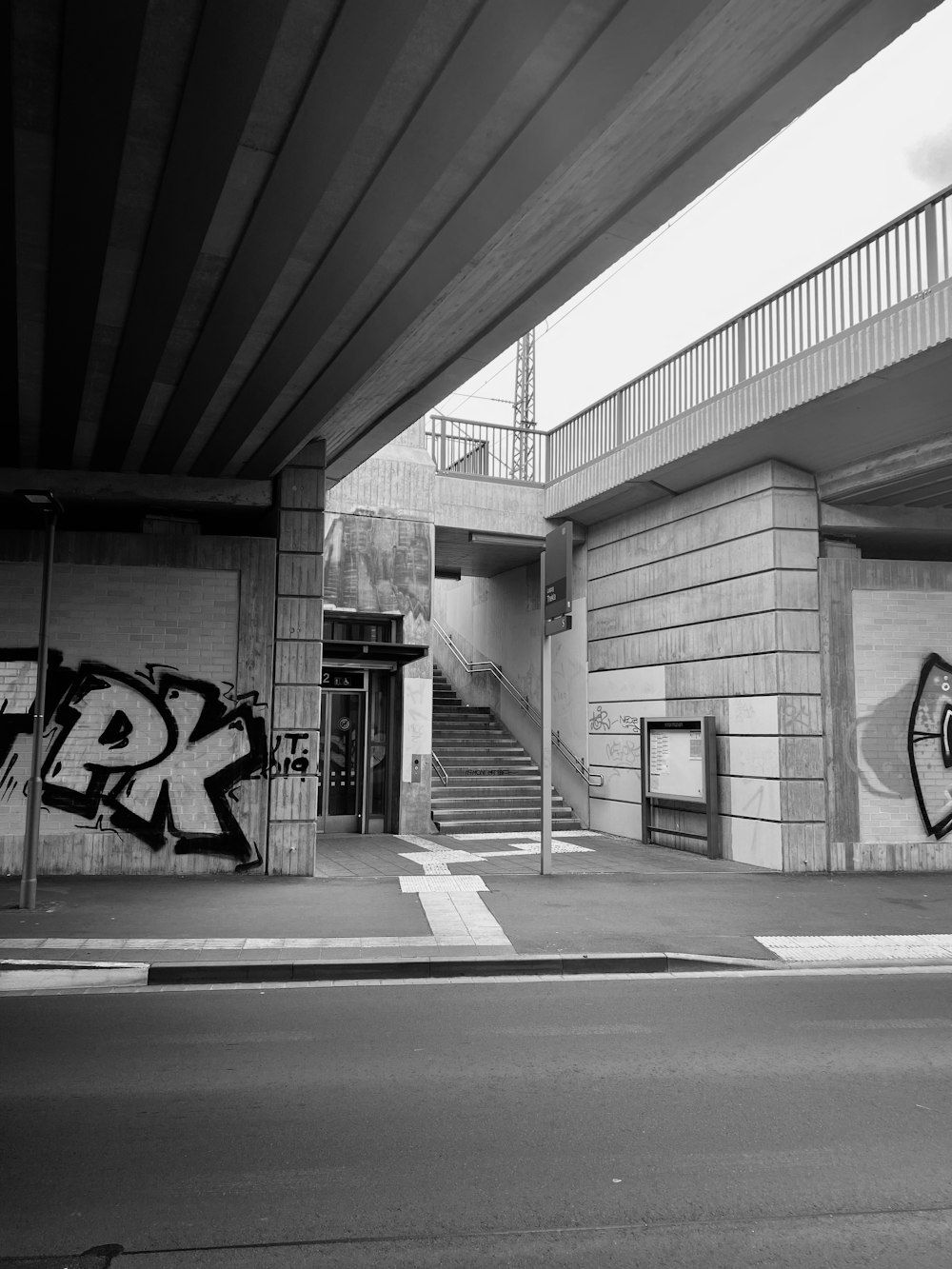 a black and white photo of a building with graffiti on it