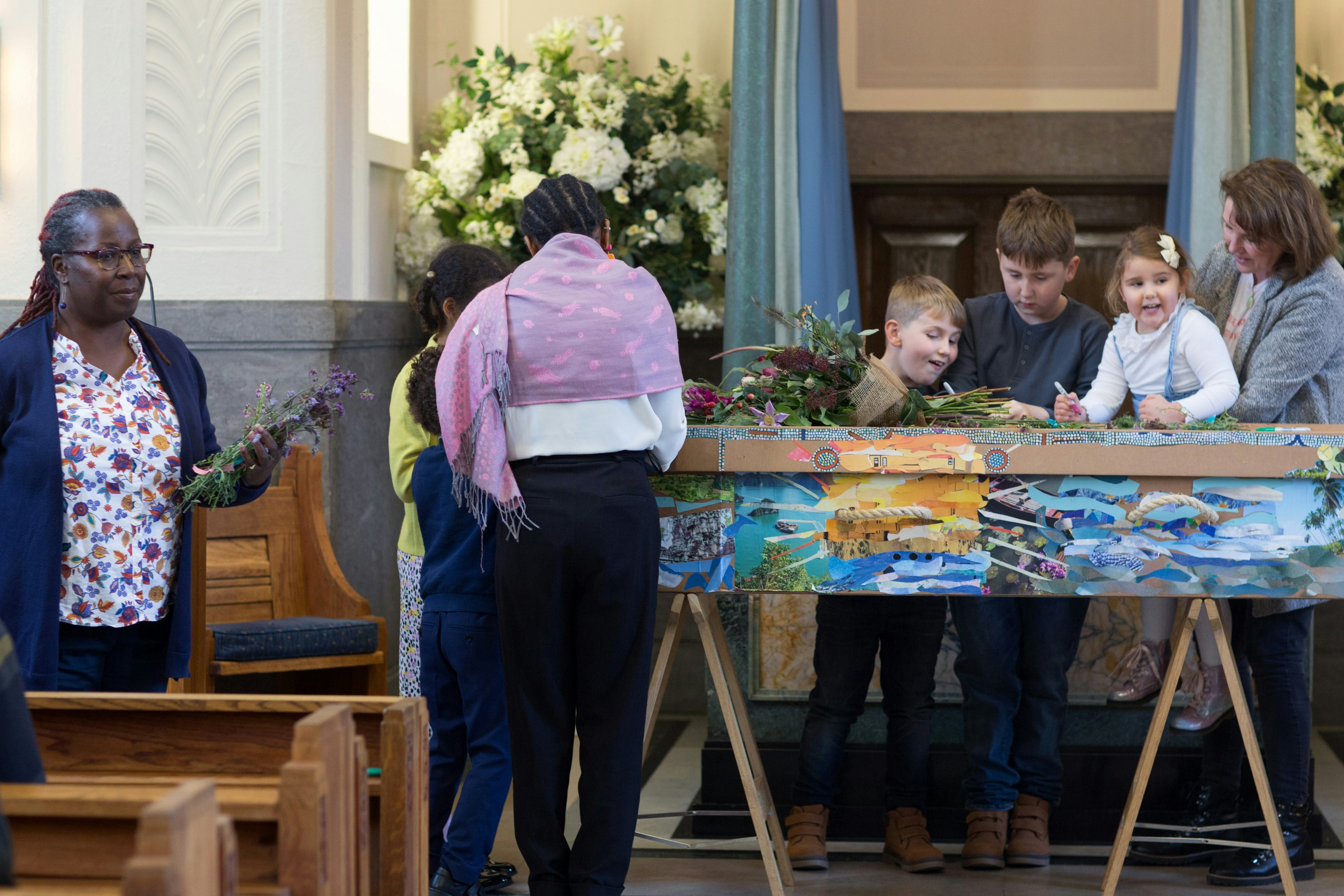 a group of people standing around a table