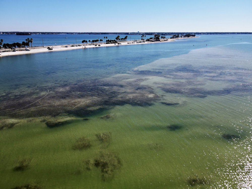 a body of water with a beach in the background