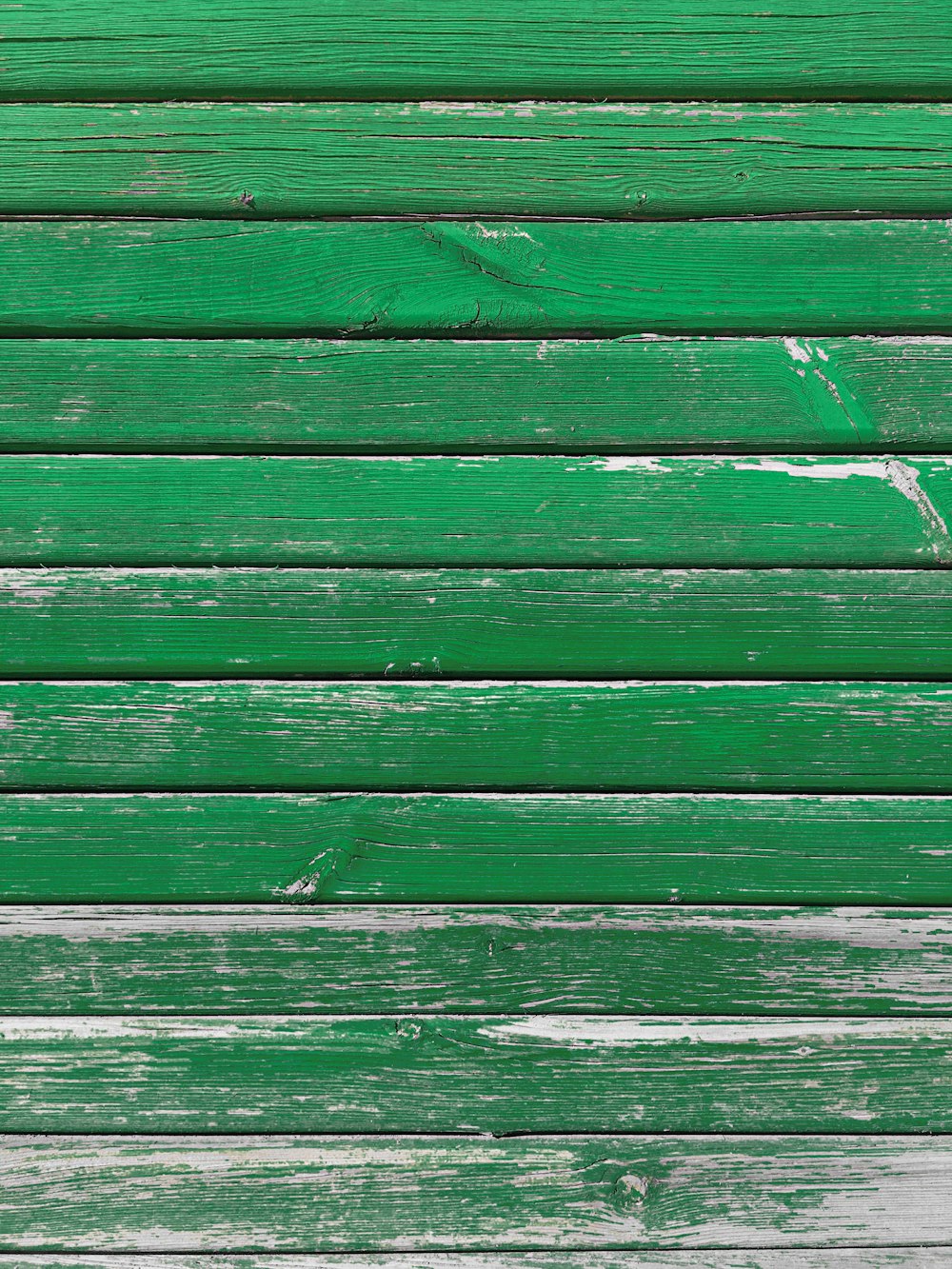a close up of a green wooden wall