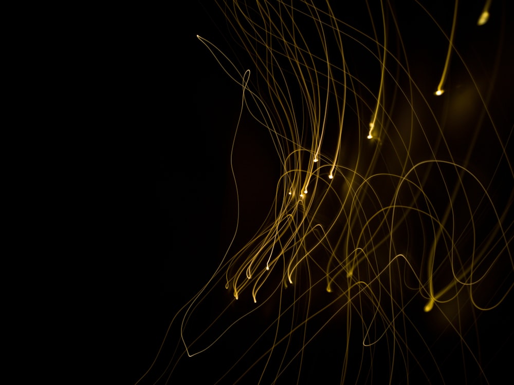 a blurry photo of yellow lights on a black background