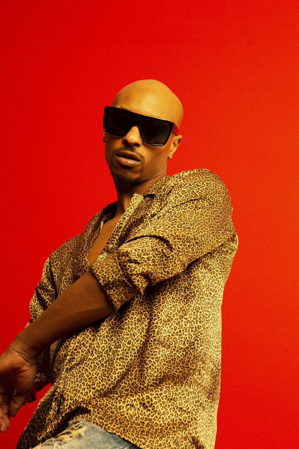 a man with a bald head wearing sunglasses