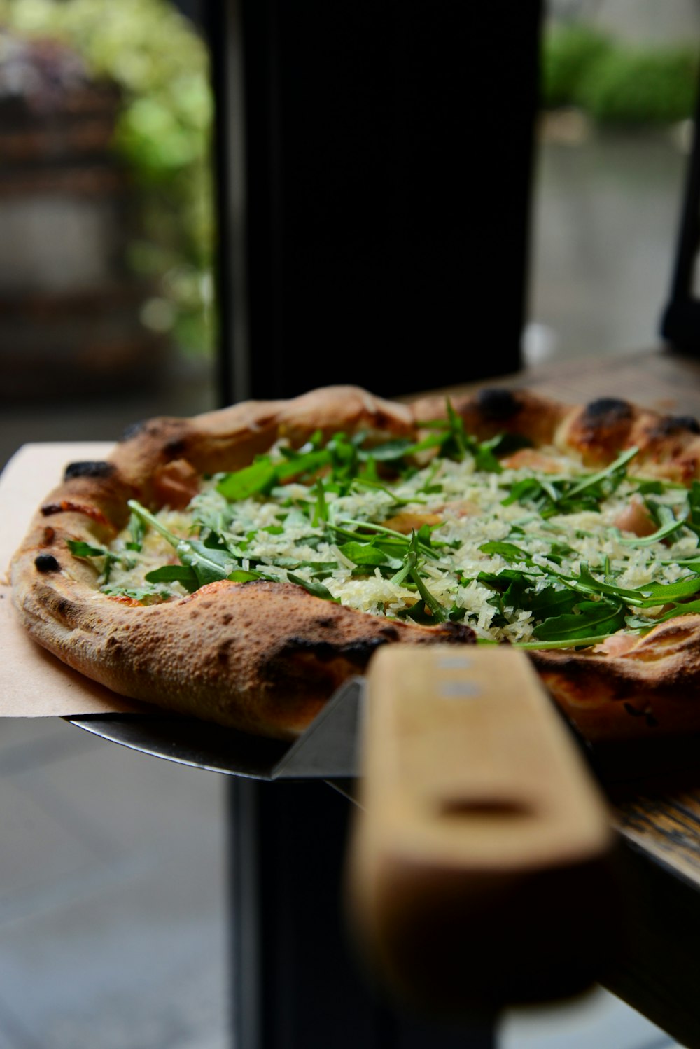 a pizza sitting on top of a wooden table