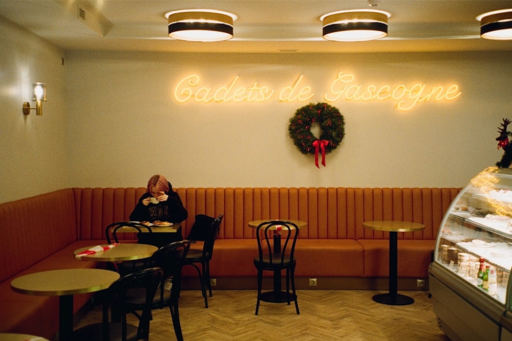 a woman sitting at a table in a restaurant