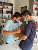 a man in a blue shirt and a man in a blue shirt and a dog