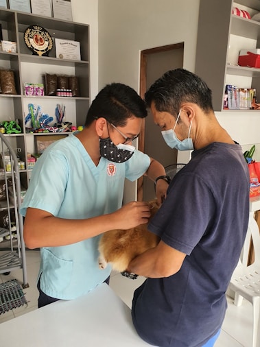 a man in a blue shirt and a man in a blue shirt and a dog