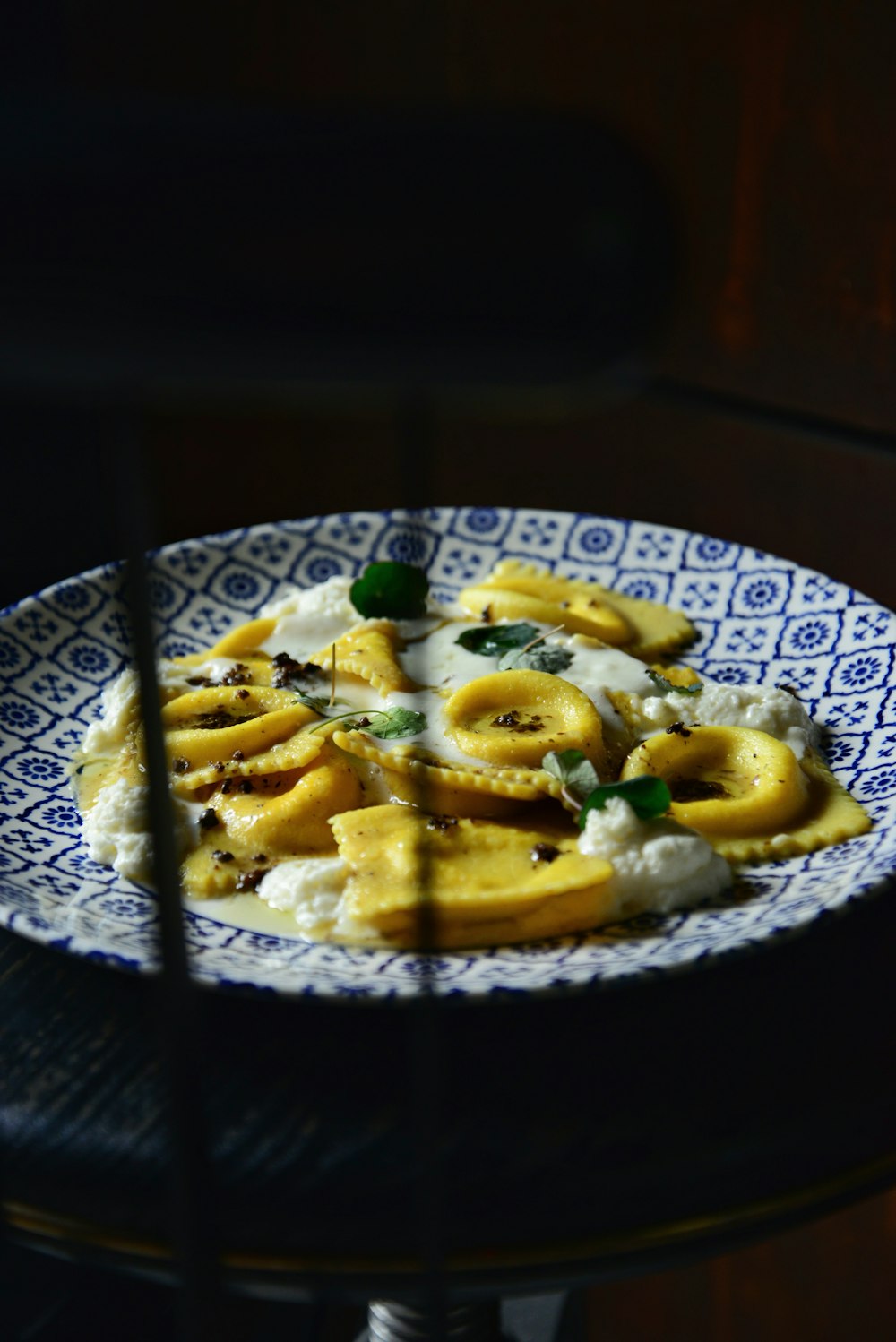 a blue and white plate topped with bananas and mashed potatoes