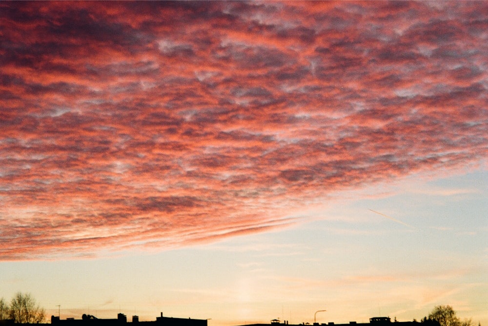 a pink and blue sky with a few clouds