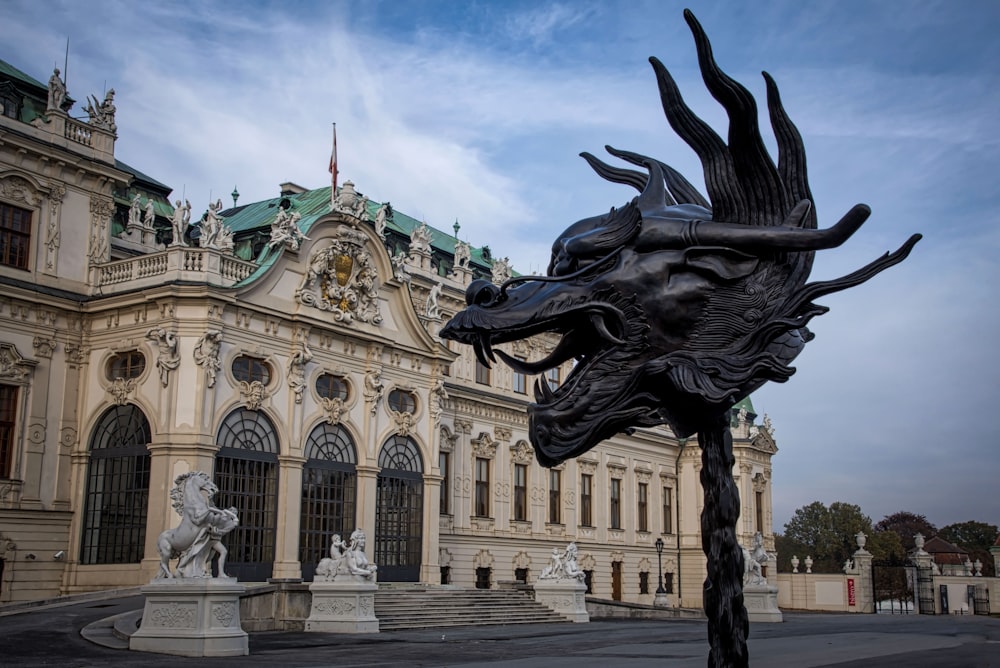 a statue of a dragon in front of a building