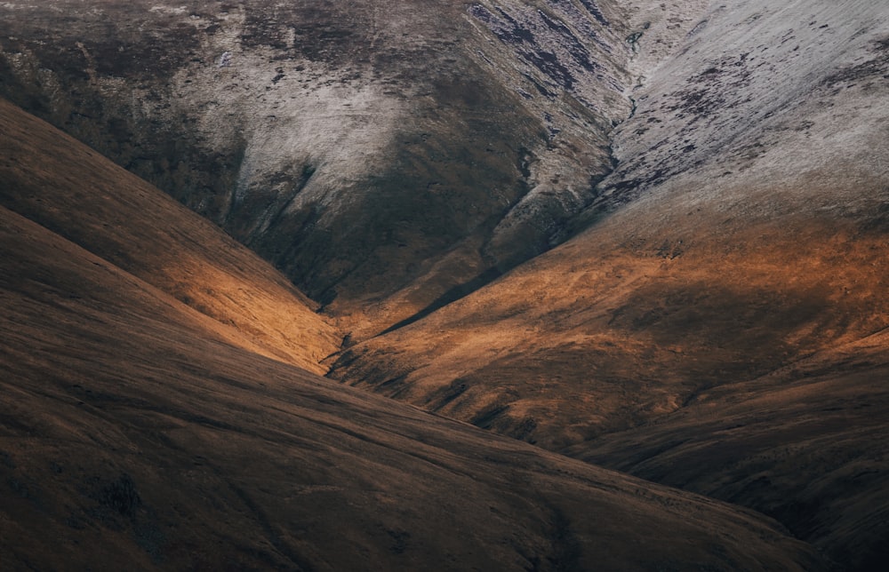 a view of a mountain range from the top of a hill