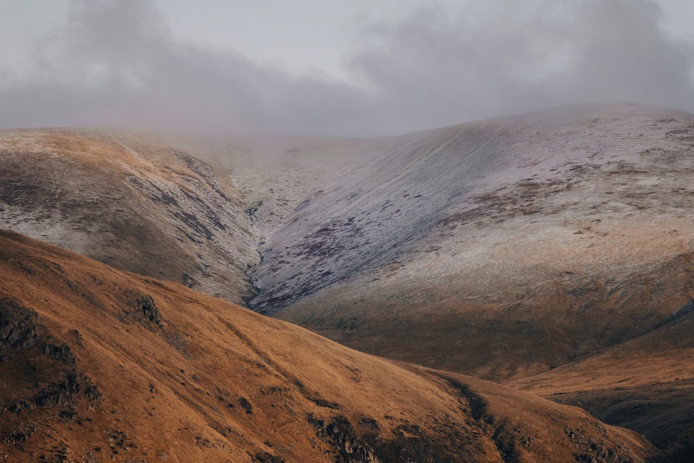 a mountain covered in snow with a few clouds