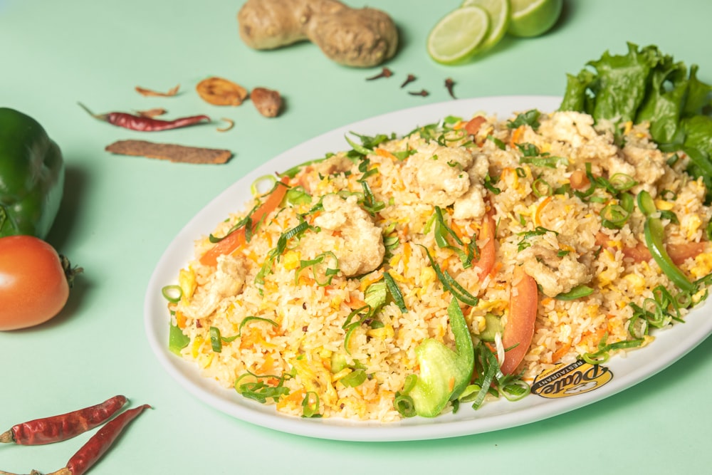 a white plate topped with rice and veggies