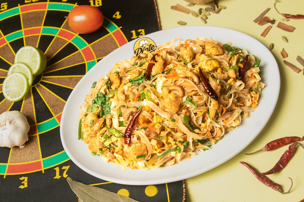 a plate of food on a table next to a dart board