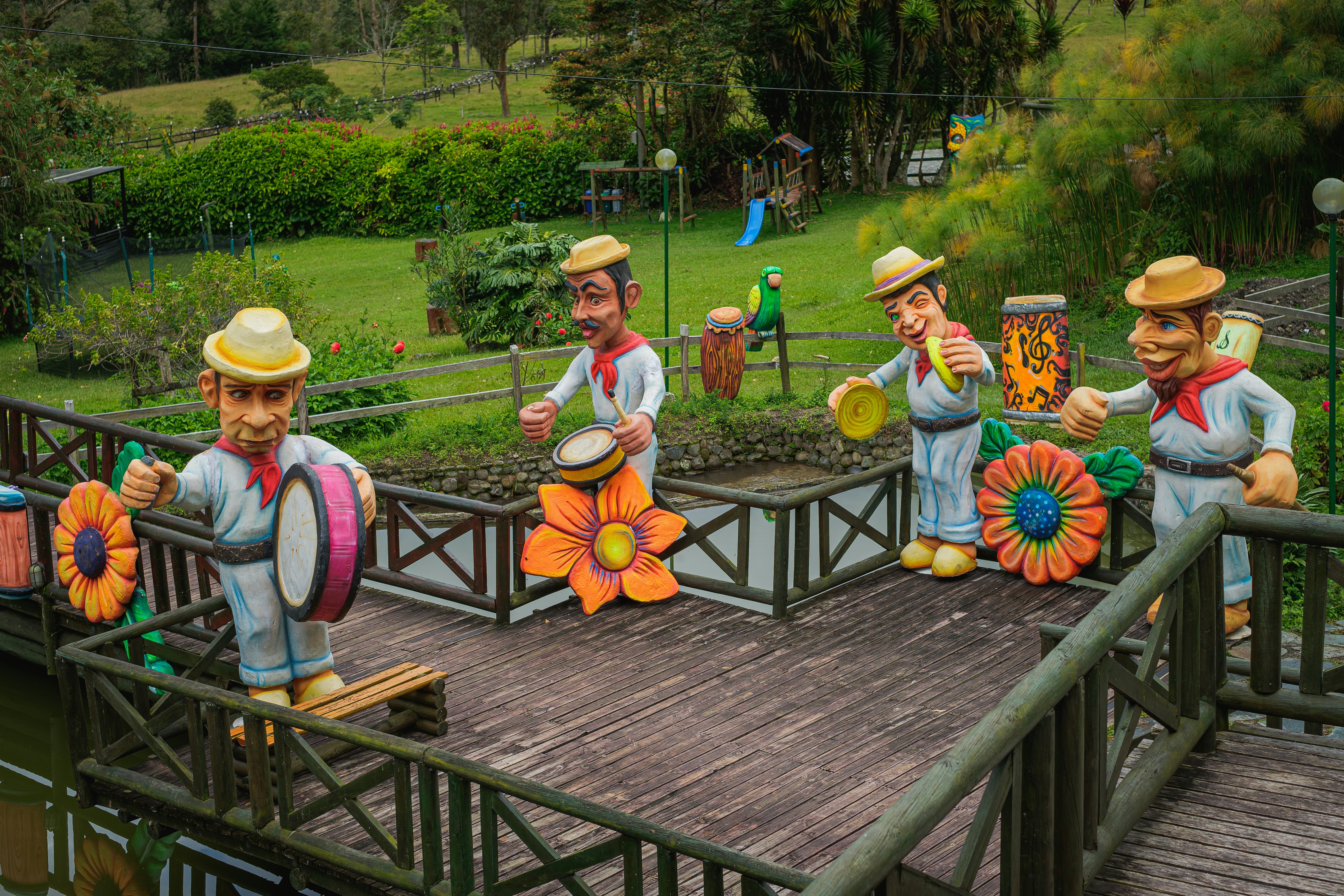 a group of statues of men on a bridge