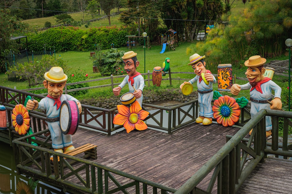 a group of statues of men on a bridge