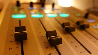 a close up of a sound board with knobs