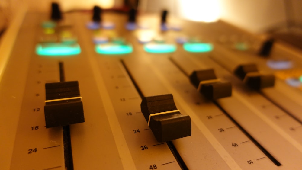 a close up of a sound board with knobs